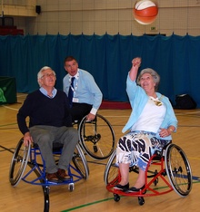 Cllr Janet Biggins (right) tries her hand at wheelchair basketball.