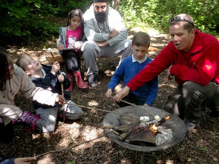 Pupils at Little Stoke Primary School toast marshmallows on a fire as part of their Forest Schools activities.