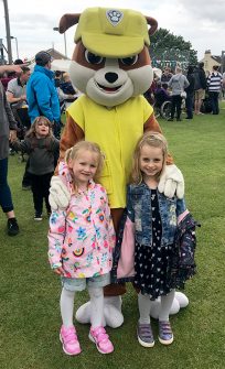 Photo of two children with a Paw Patrol character.