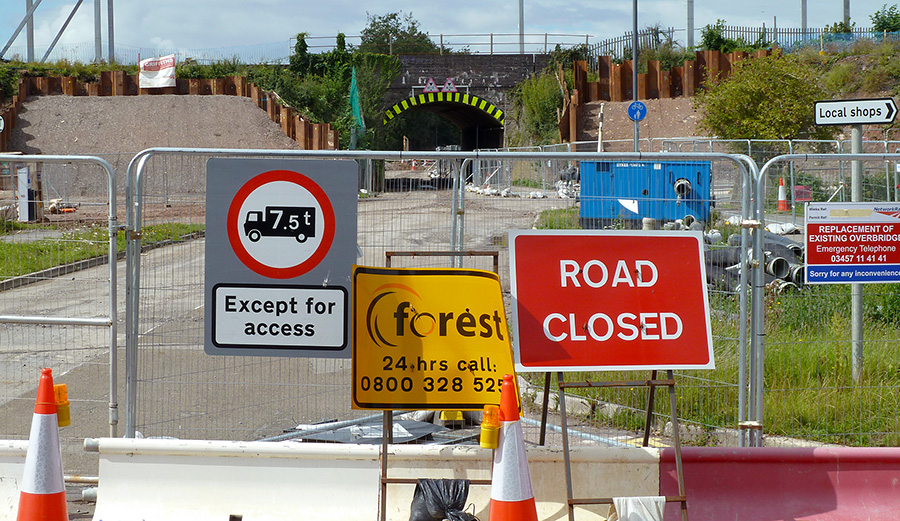 Photo of road closure signs and barriers.