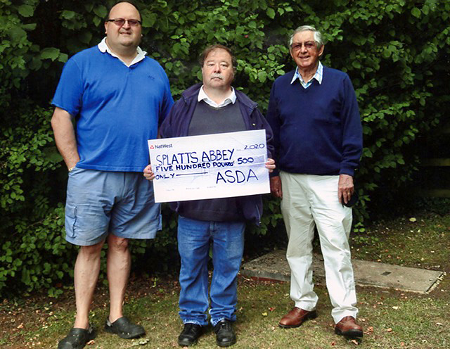 Photo of volunteers holding a cheque for £500.