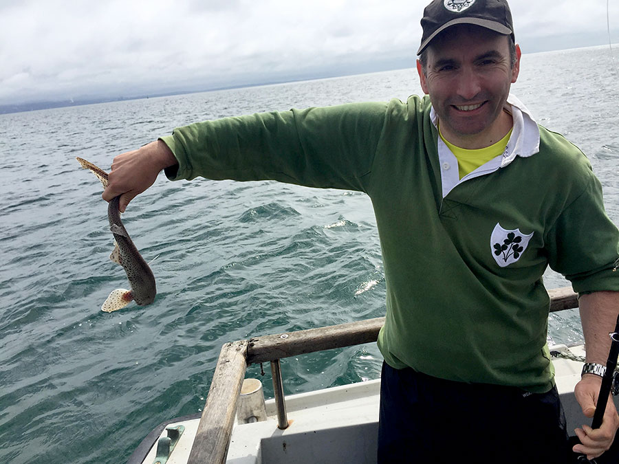Photo of Simon Guy catching fish.