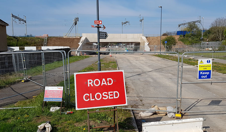 Photo of a 'road closed' sign in front of a bridge.