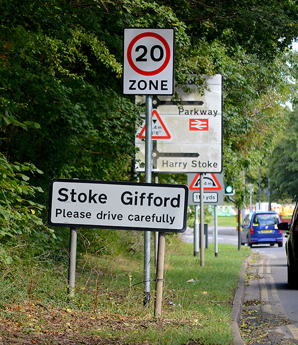 Photo of a 20mph road sign, amongst other signs.