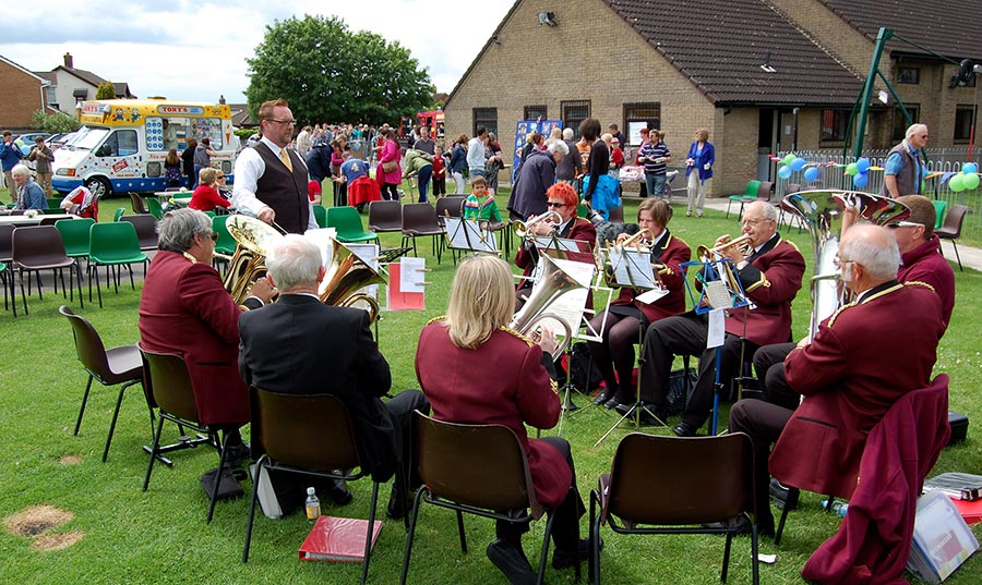 Photo of a brass band playing at a fête.
