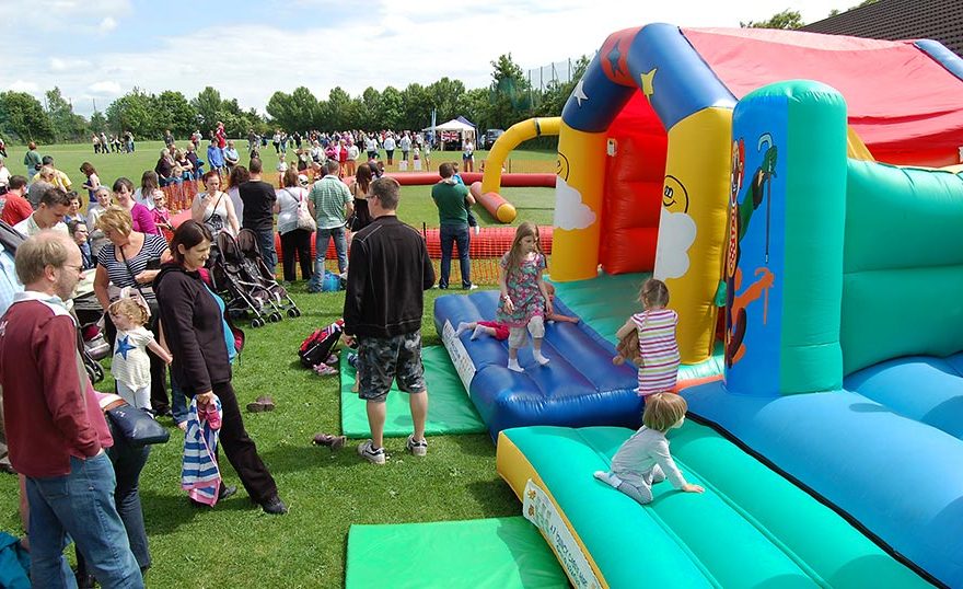 Photo of a fête taking place on a sports field.