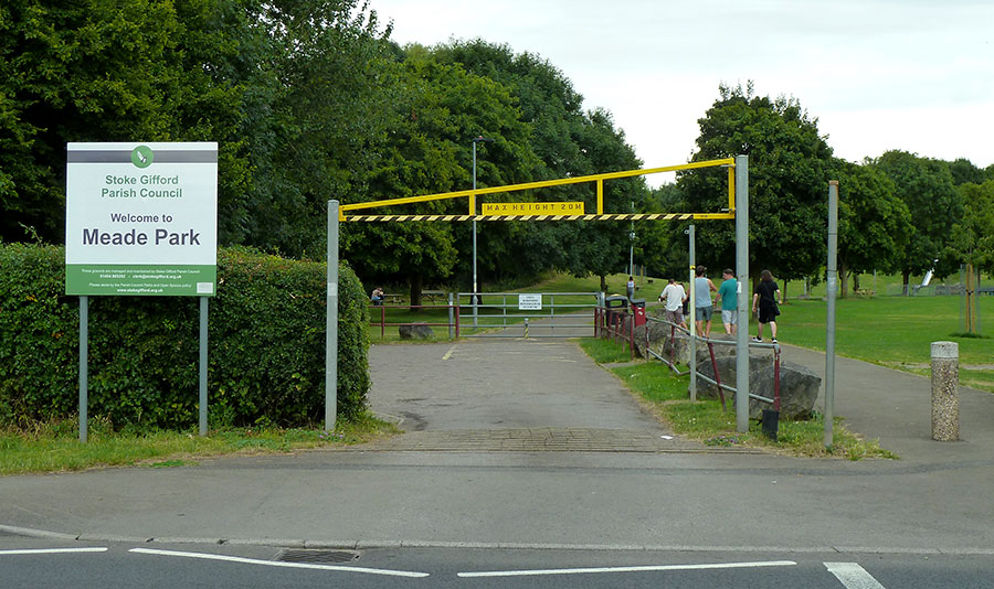 Photo of the entrance to a car park, with height restriction barrier.