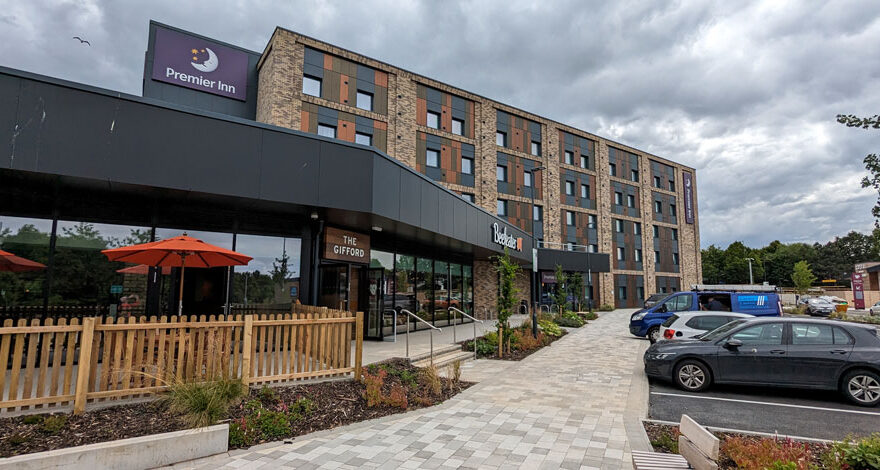 Photo of a Beefeater restaurant with a Premier Inn in the background.