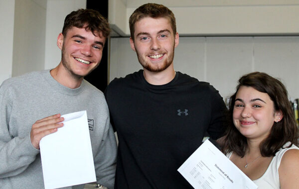 Photo of a group of students holding envelopes.