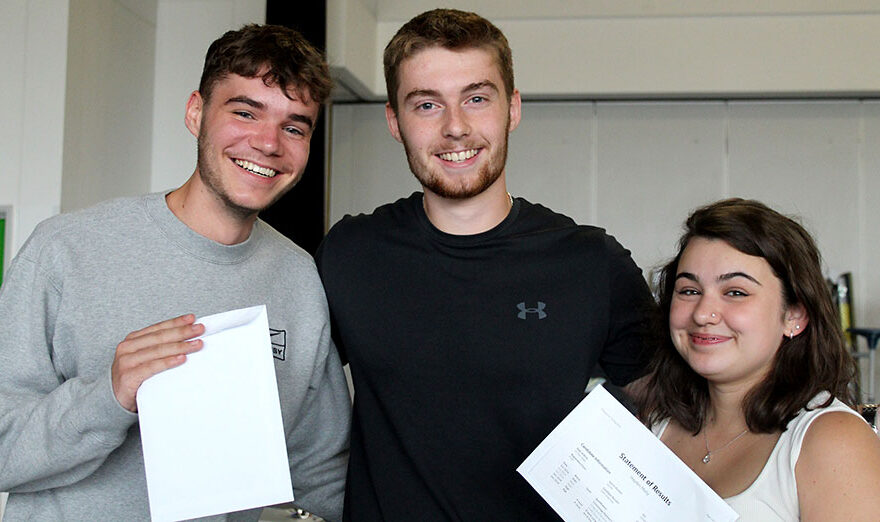 Photo of a group of students holding envelopes.