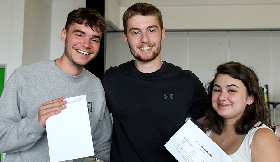 Photo of a group of students holding envelopes.