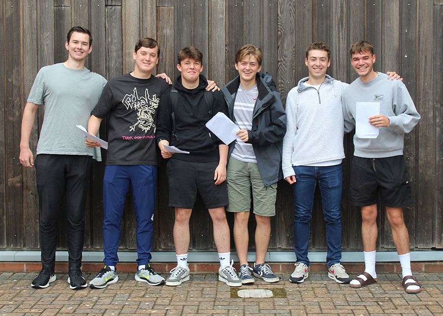 Photo of a group of students holding envelopes.